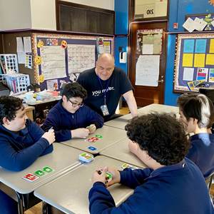 Students at Gary Elementary School play a card game