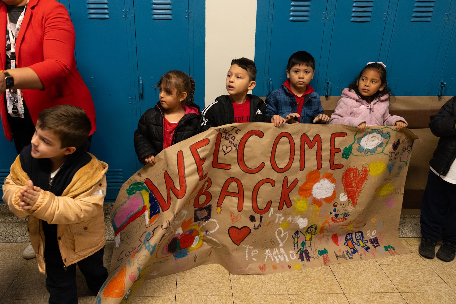 students holding welcome back sign