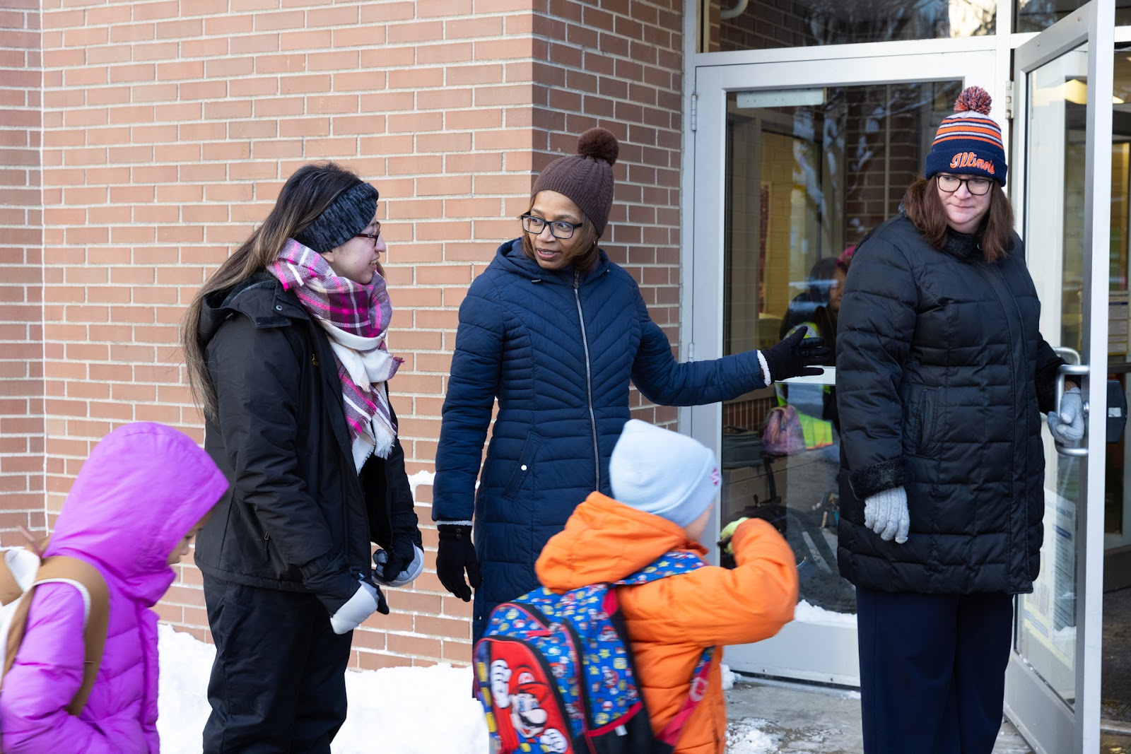 Dr. Macquline King, students, and staff entering a school