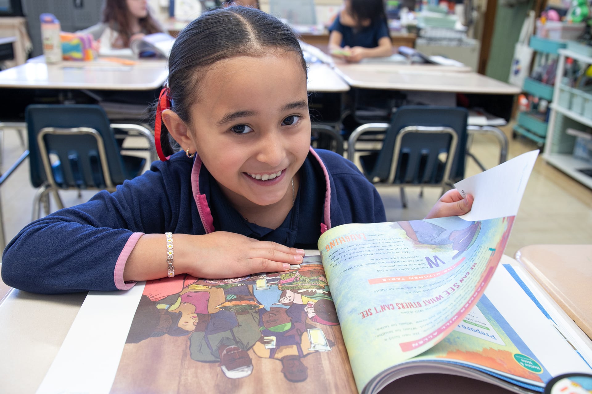 smiling student reading a book