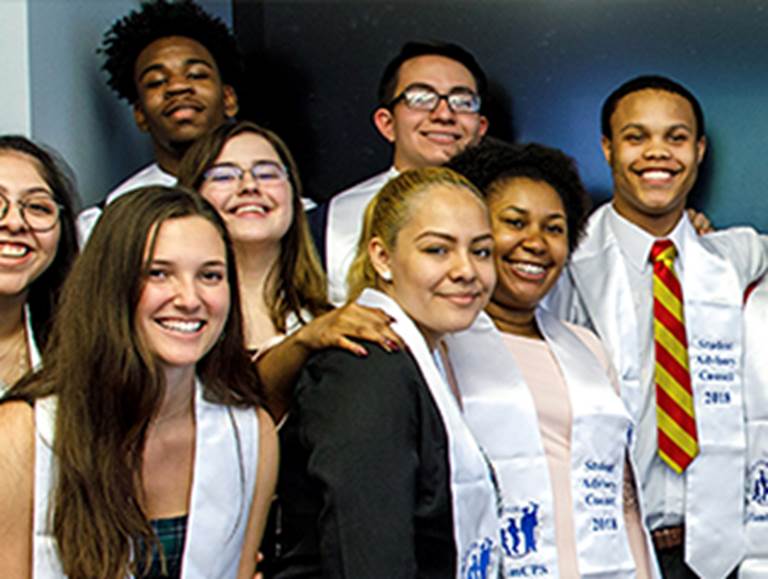 Eight students wearing sashes that say Student Advisory Council 2018