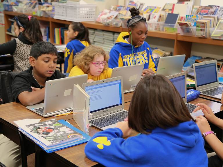 Elementary school students working on laptops