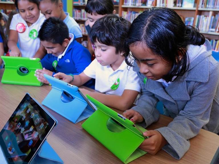 Group of young students learning on ipads