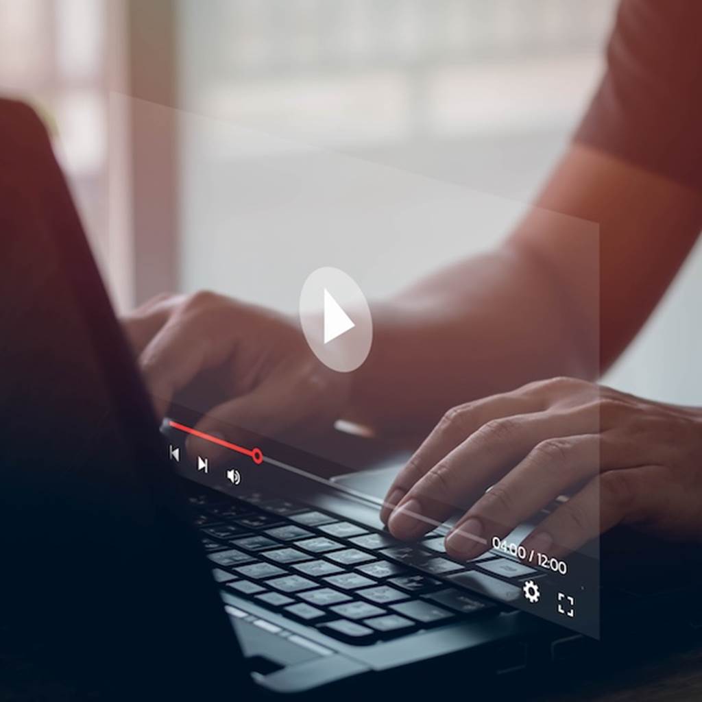A video plays on a laptop computer