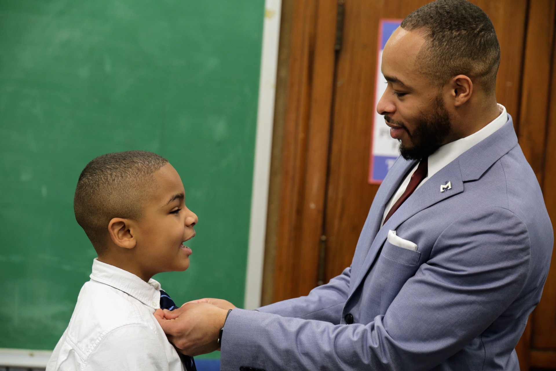 teacher straightening student's tie