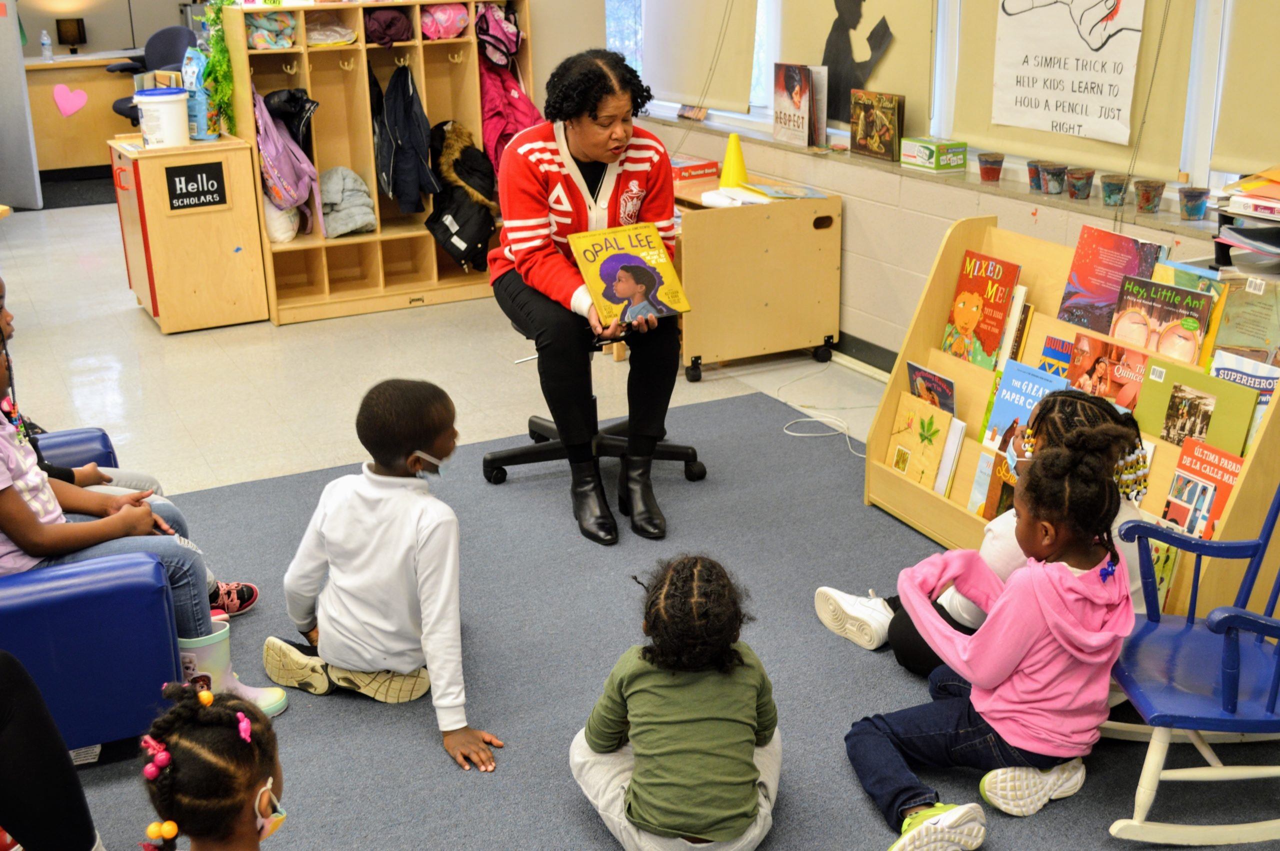Teacher reading Opal Lee to a group of young students