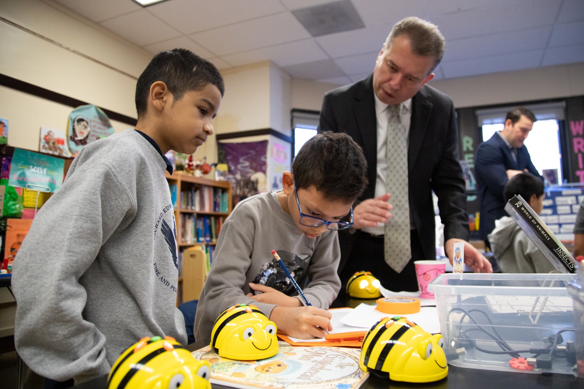 CEO watching young students at work