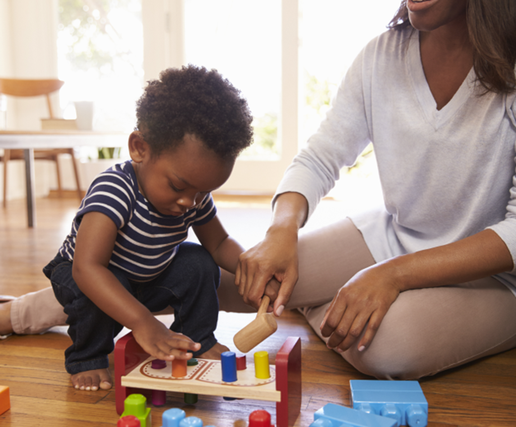 Toddler plays at home with an early childhood education instructor