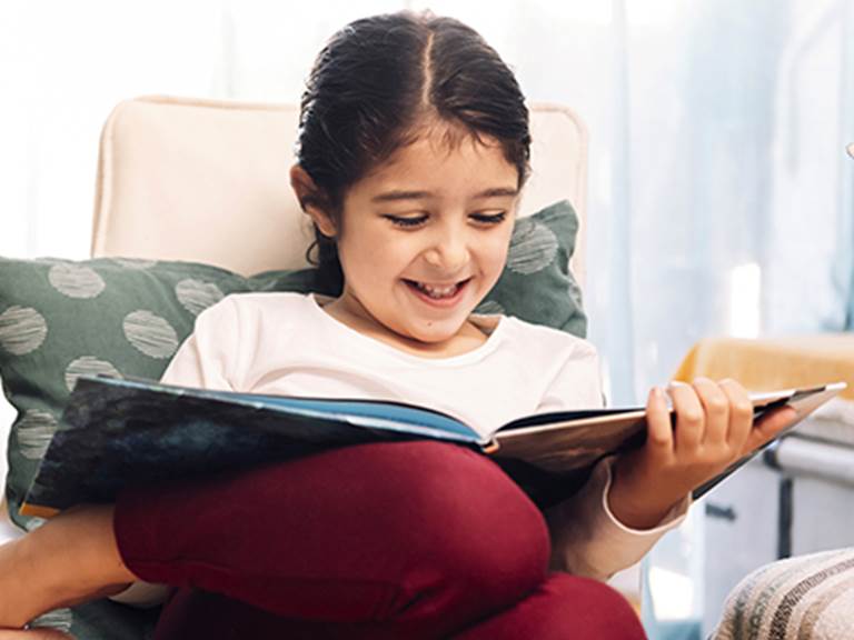 Girl reading book at home