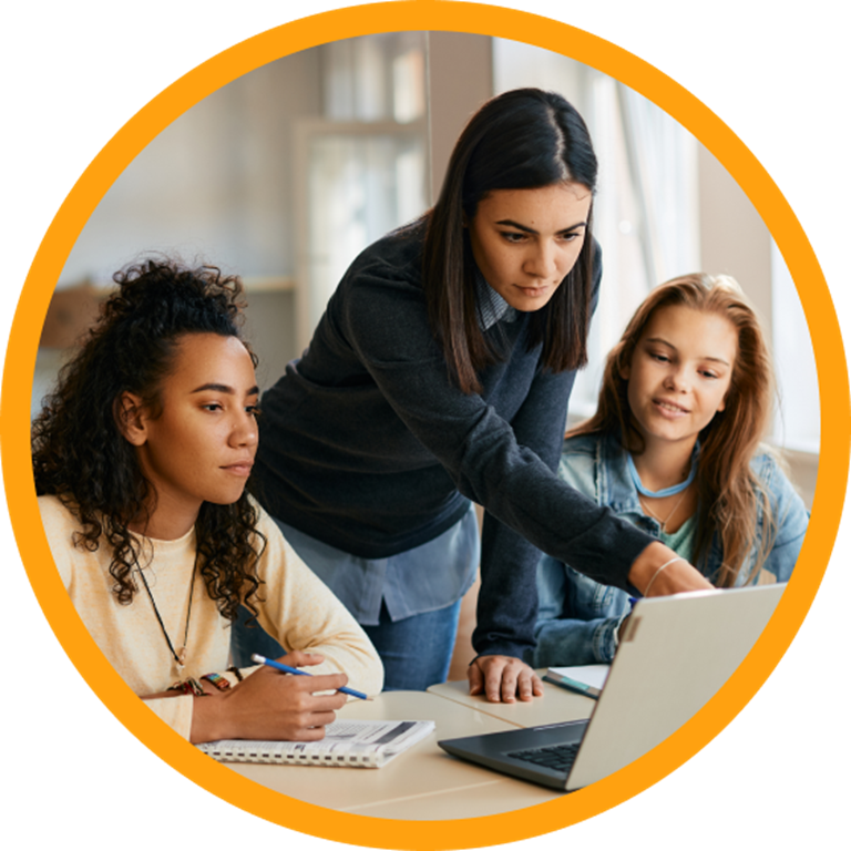 Teacher and two students using a laptop