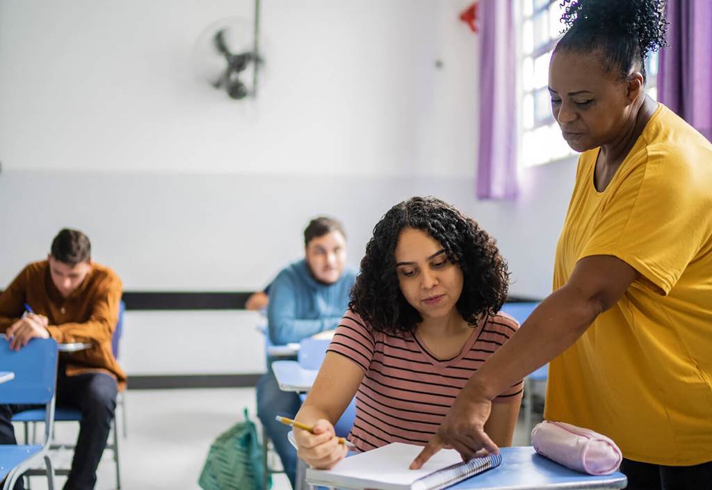 image of teacher helping student with work