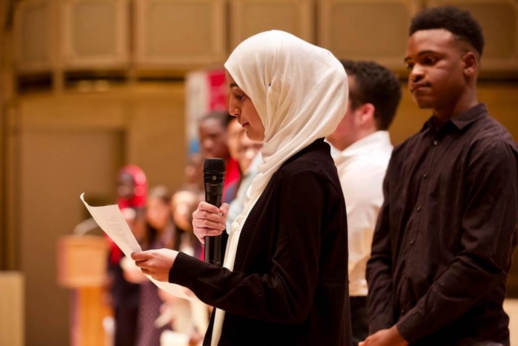 A student speaks with a microphone
