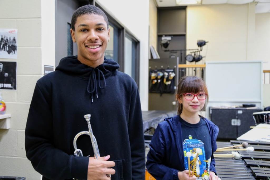  Whitney Young juniors Miles Hardemon, a trumpet player, and Sui Lin Tam, a percussionist pose with their musical instruments