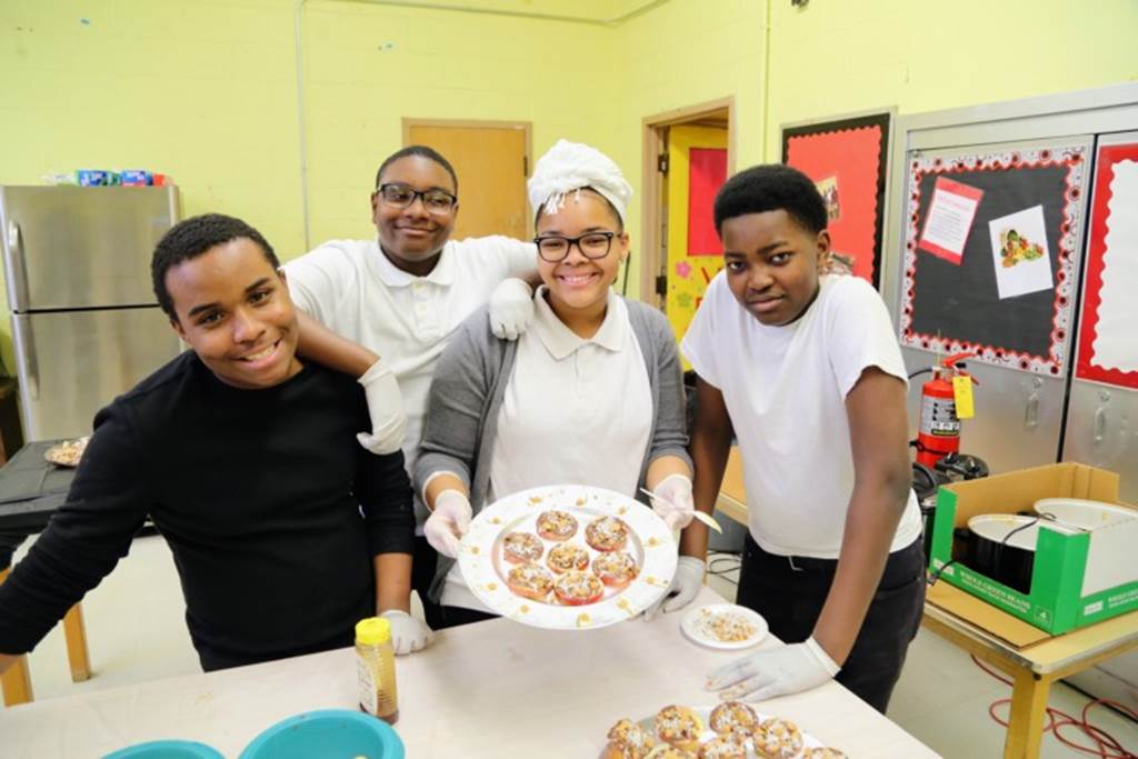 Students prepare food with chef