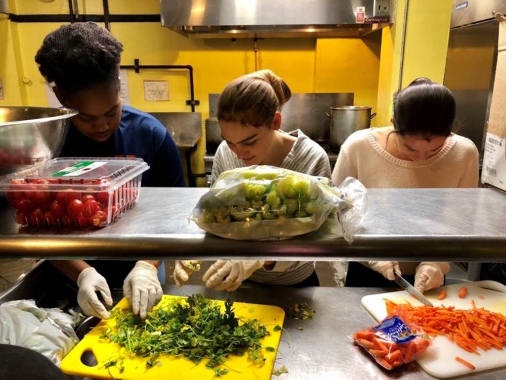 Students chopping vegetables