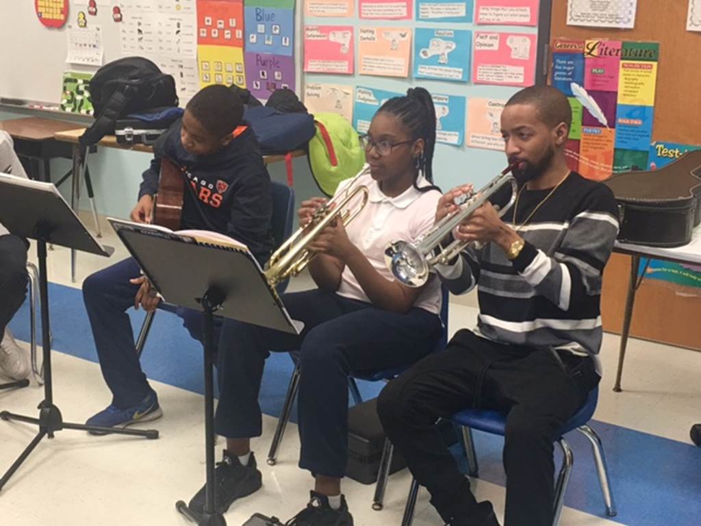 Students play songs on their musical instruments