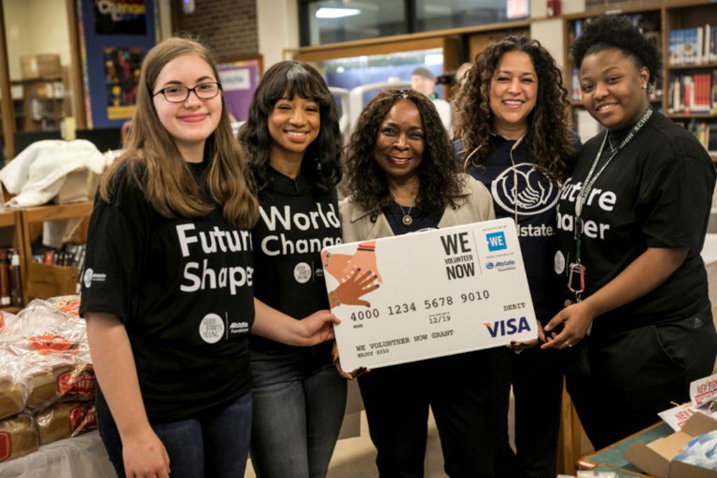 Students holding a giant debit card
