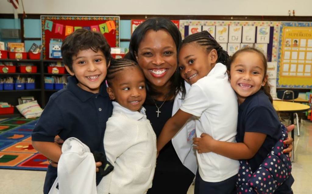 Janice Jackson posing with students