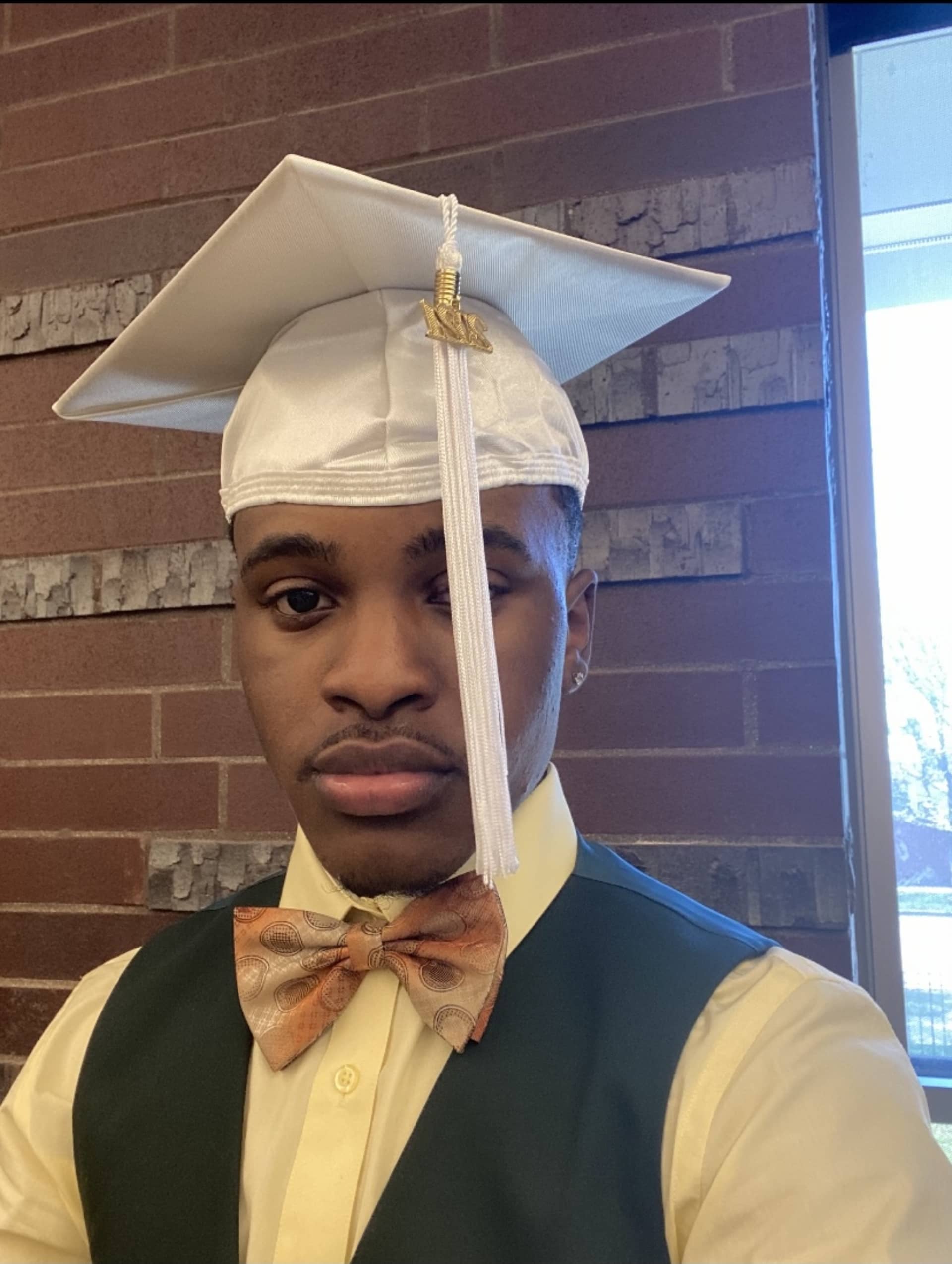 Amoni in his graduation cap