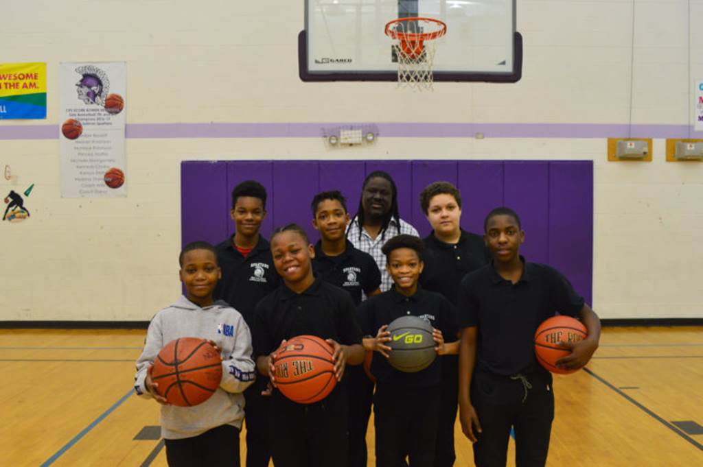 Students holding basketballs