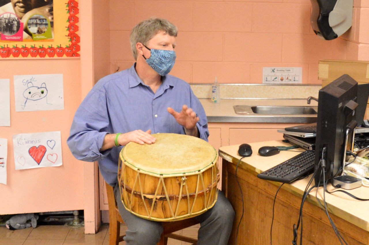 Mr. Gunn playing a drum in class