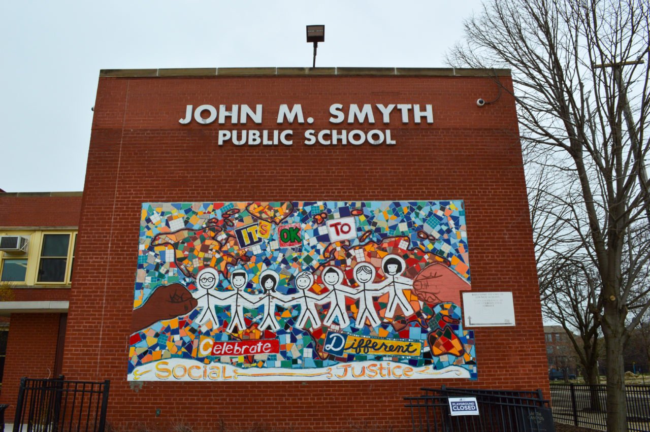 A painting stating that it's okay to celebrate different on the Smyth school building