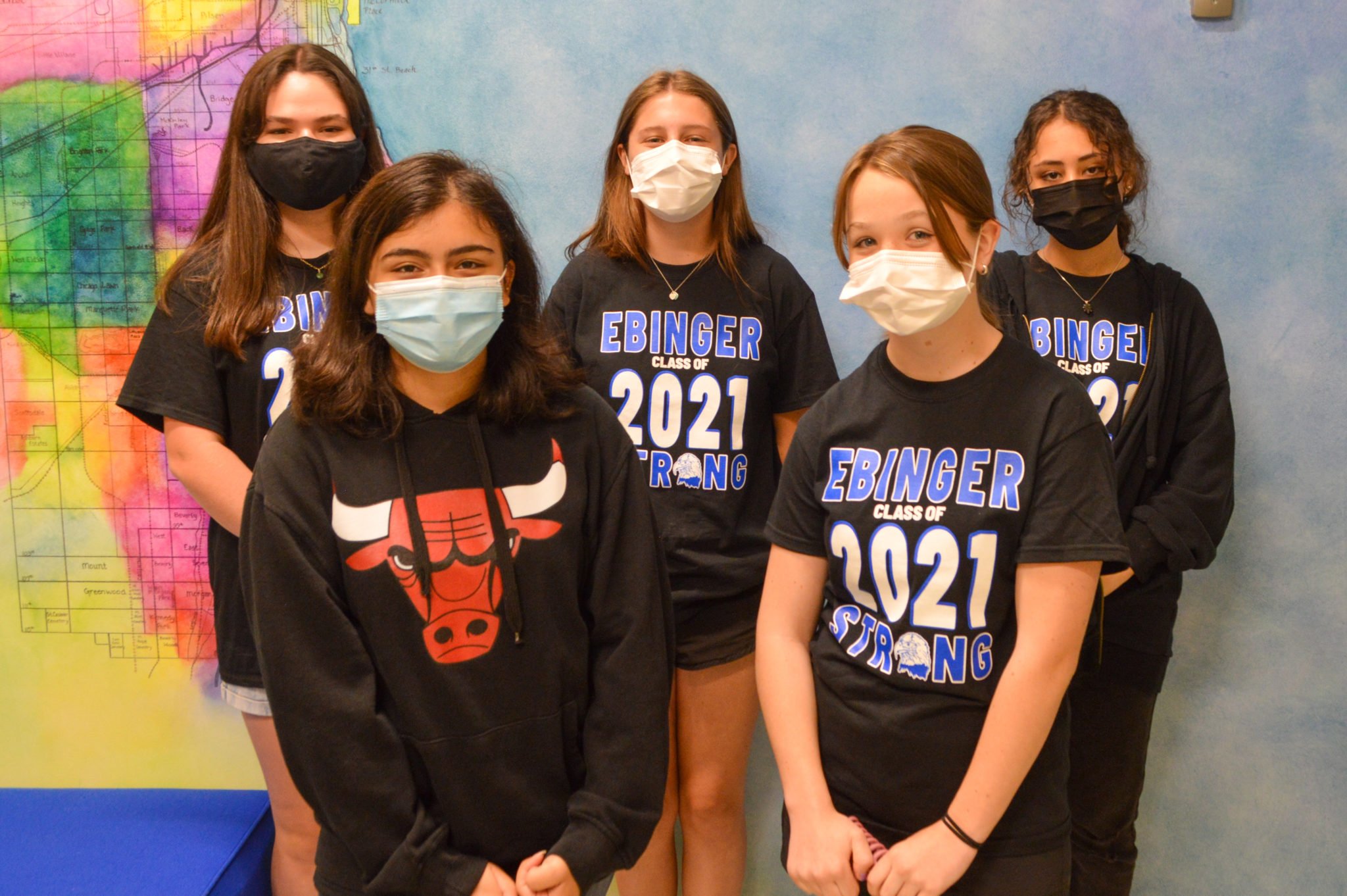 Five girls wearing face masks