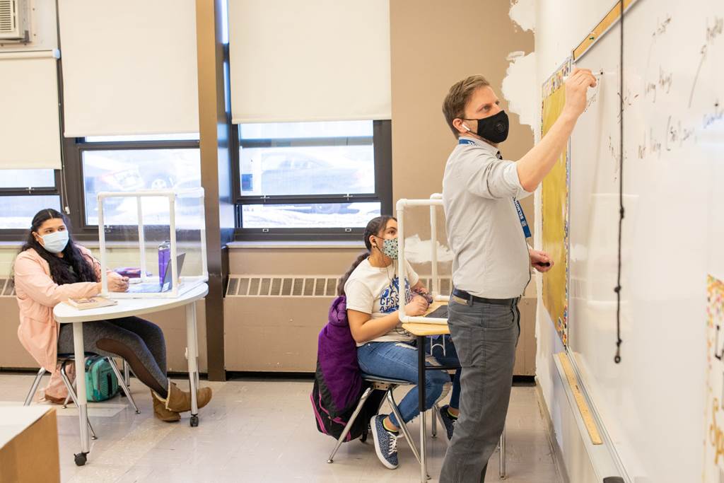 A teacher using a whiteboard