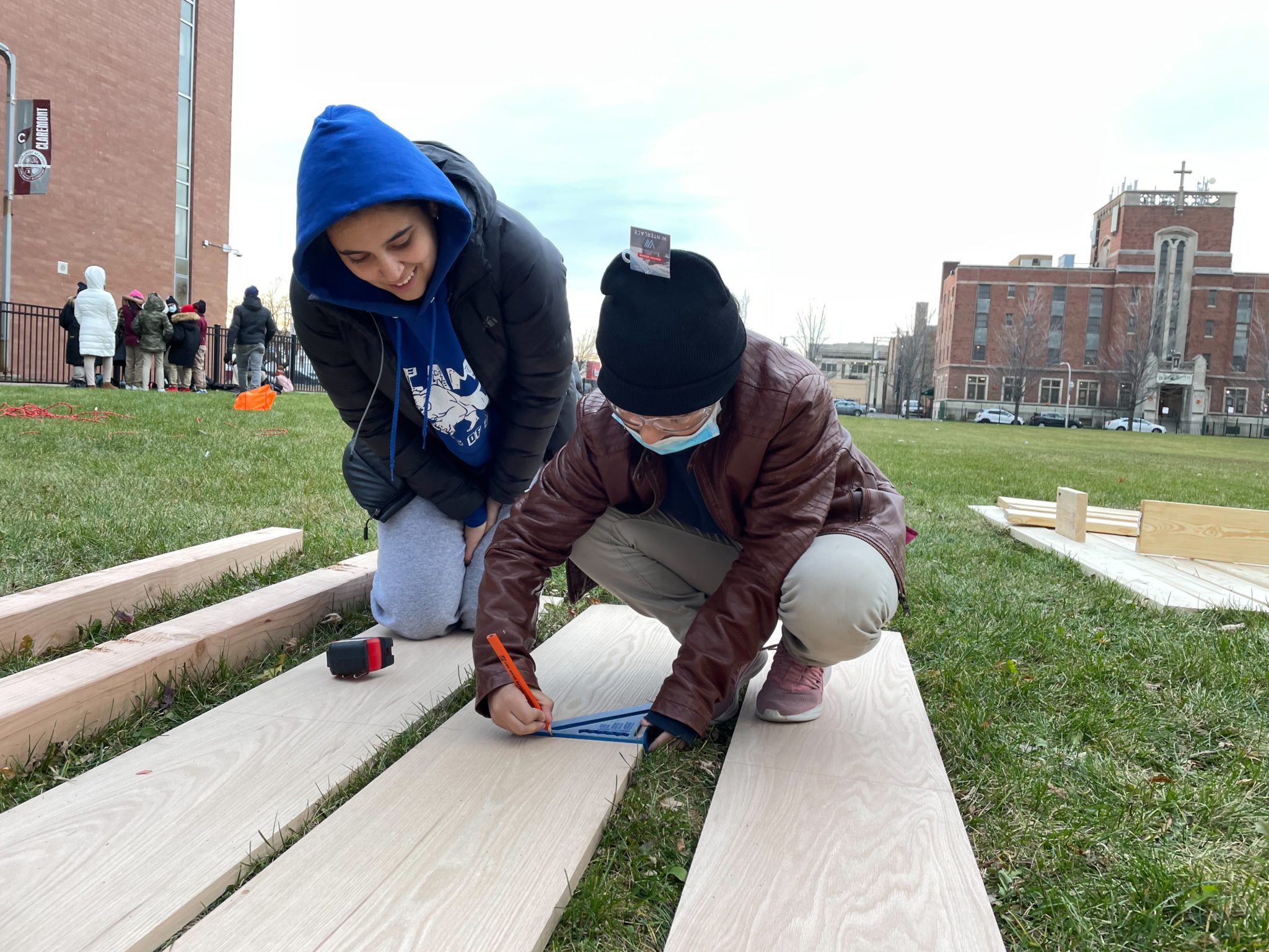 Students measuring wooden planks