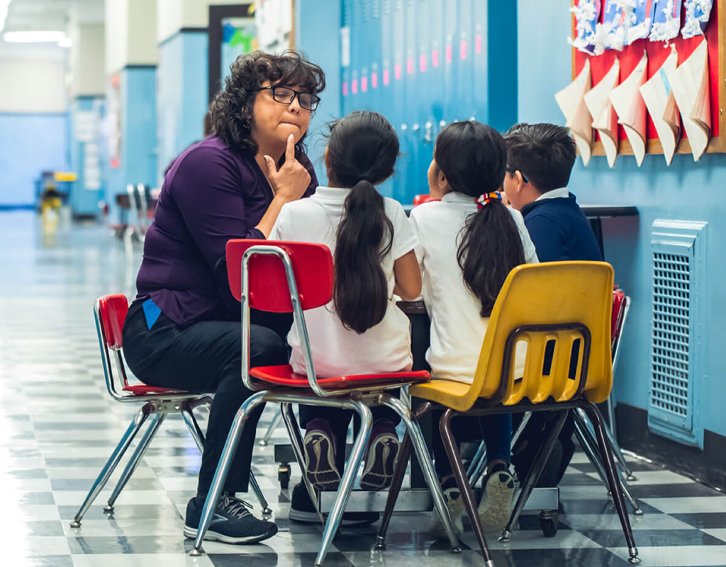 Teacher communicating with 3 children