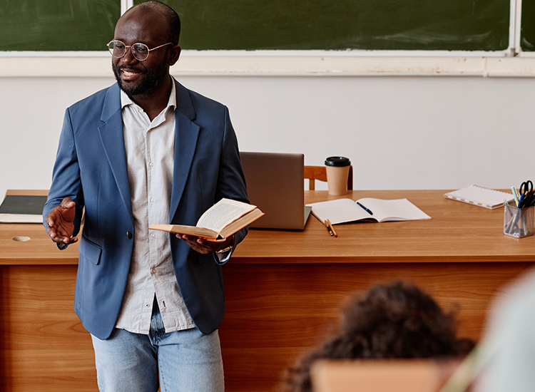 Teacher reading in front of a classroom