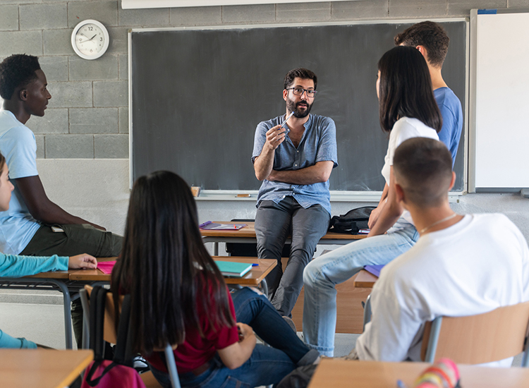 Teacher talking with a group of students