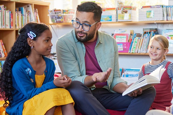 Teacher reading to two students